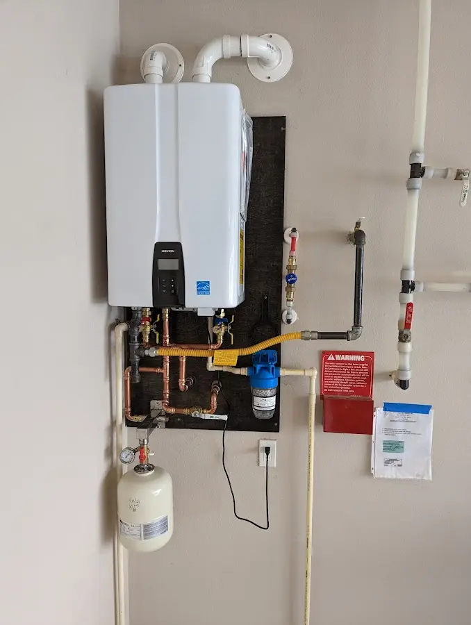 Professional plumber installing copper piping in a Shamong home